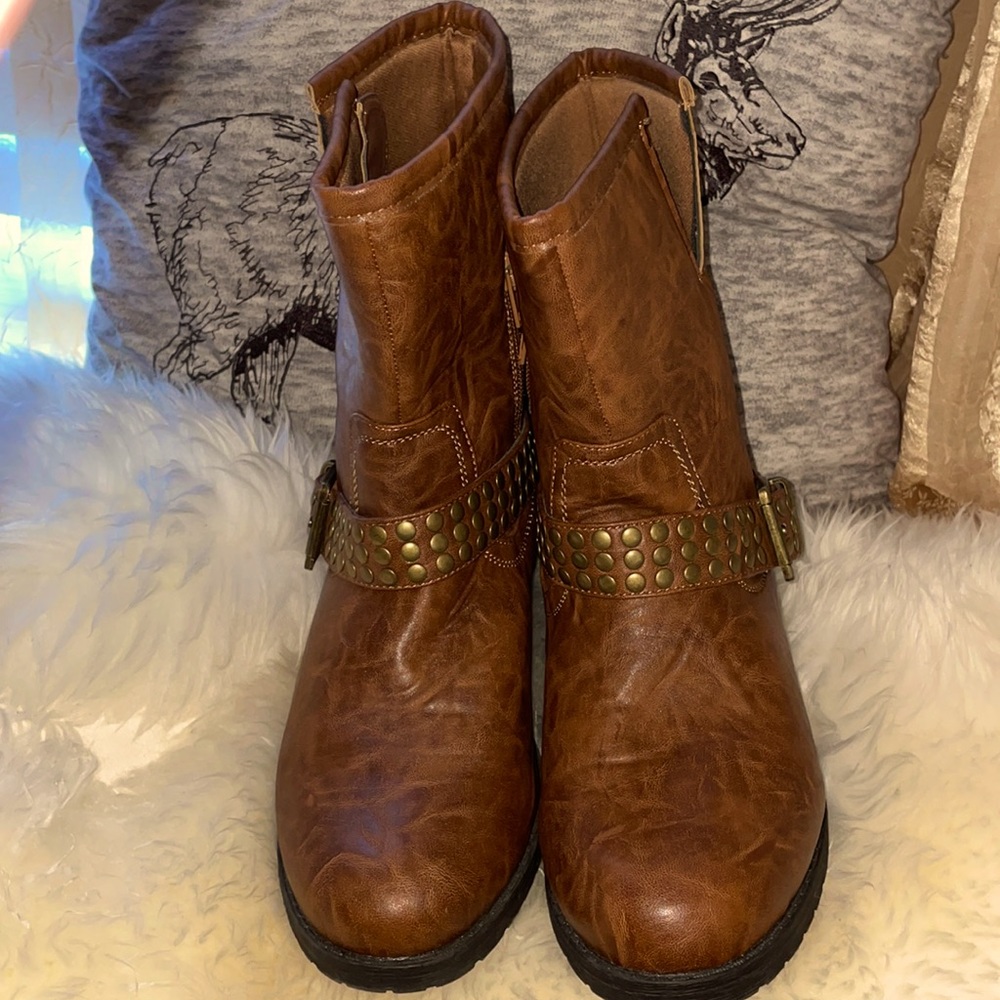Brown ankle boots with beaded heel back and strap going across with a buckle